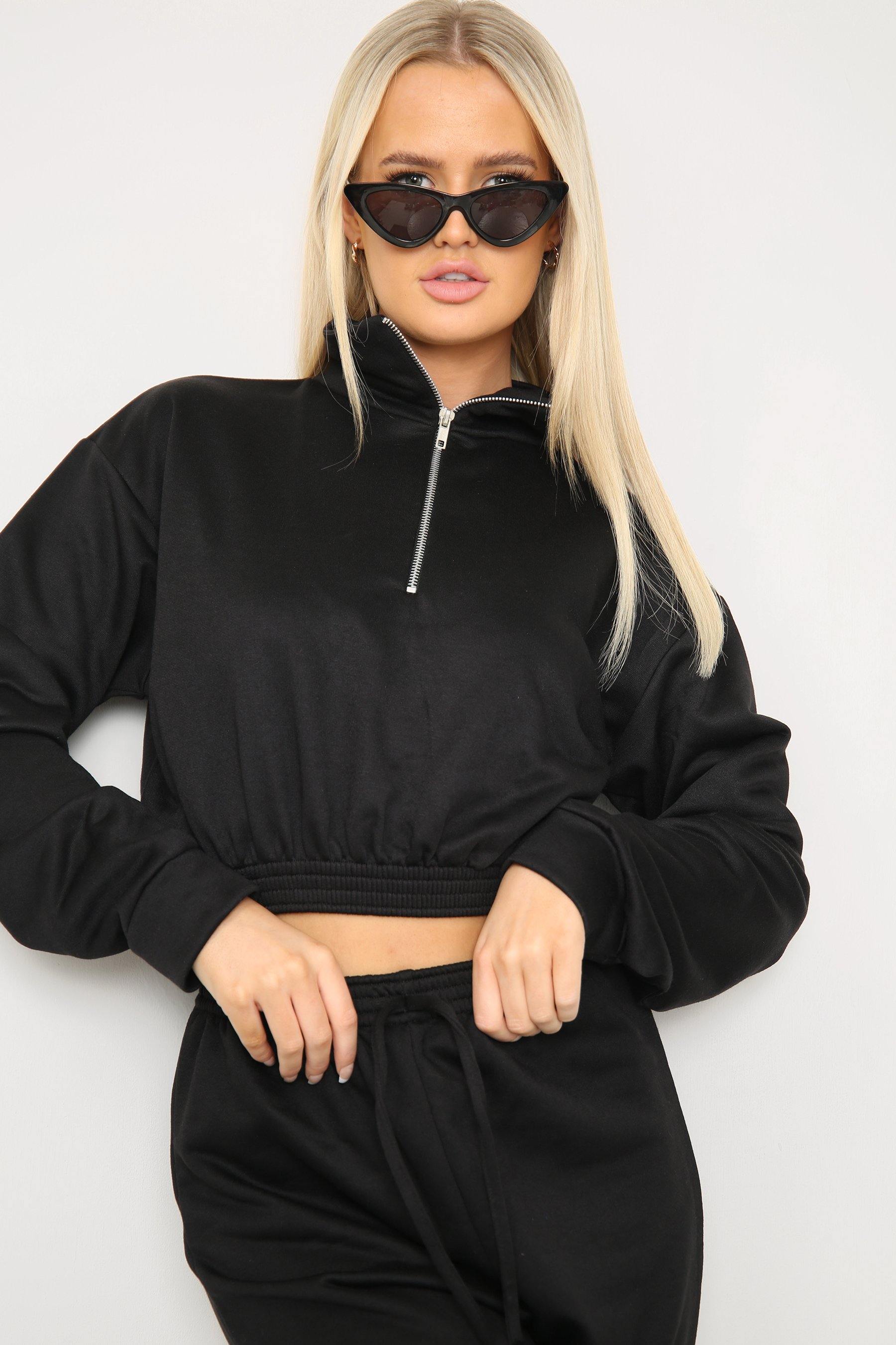 Closeup of zipper detail on long sleeve crop top with oversized matching joggers
