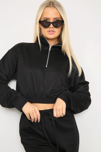 Closeup of zipper detail on long sleeve crop top with oversized matching joggers
