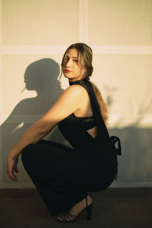 Closeup detail of scuba high neck tie waist wide leg jumpsuit fabric