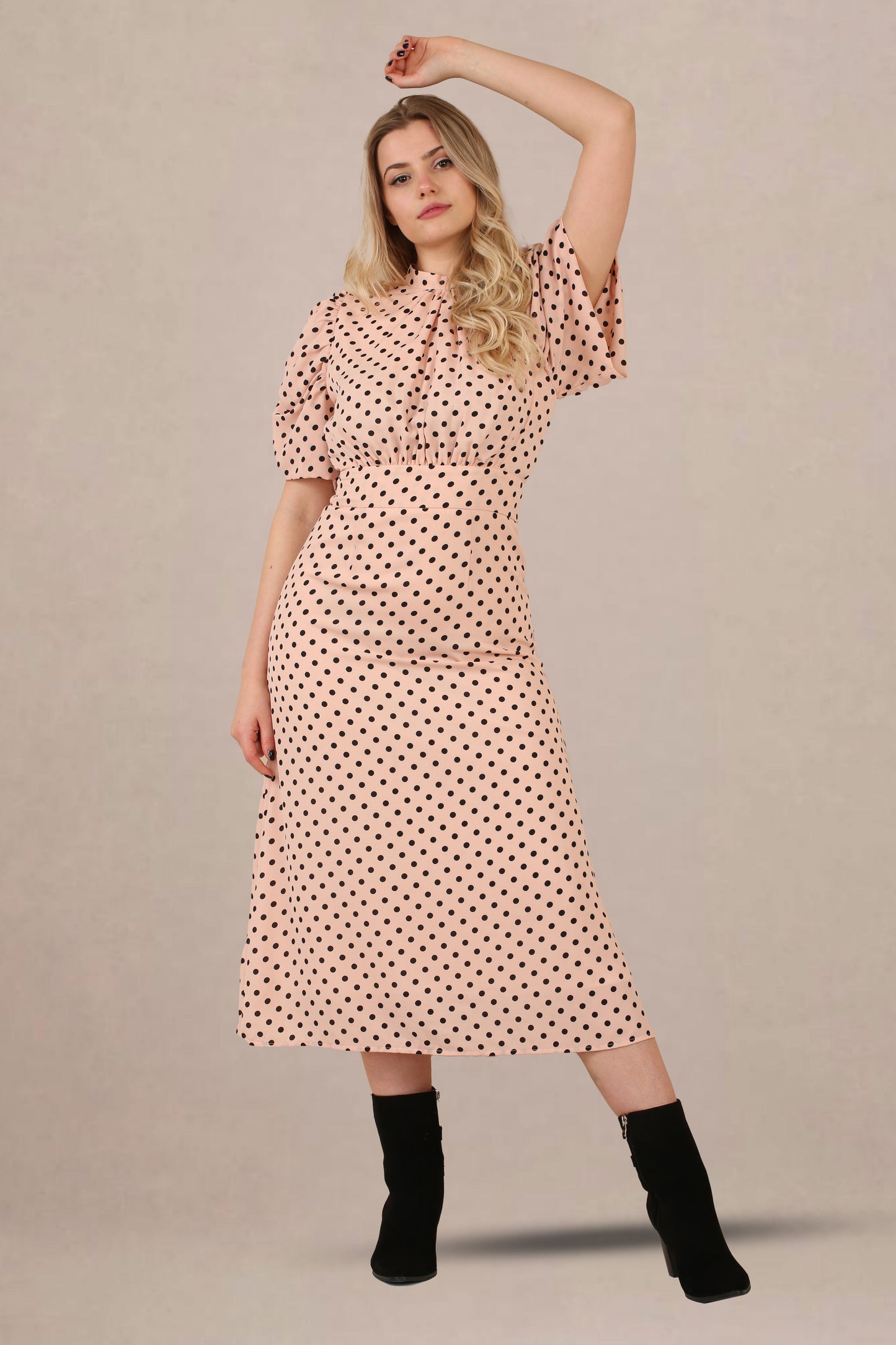 Front closeup view of vintage-inspired puff sleeves polka dot midi dress