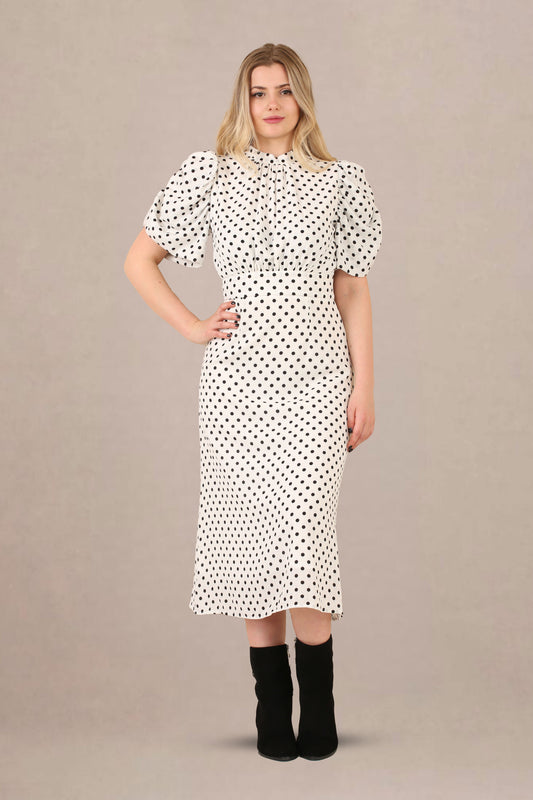 Front view of vintage-inspired puff sleeves polka dot midi dress