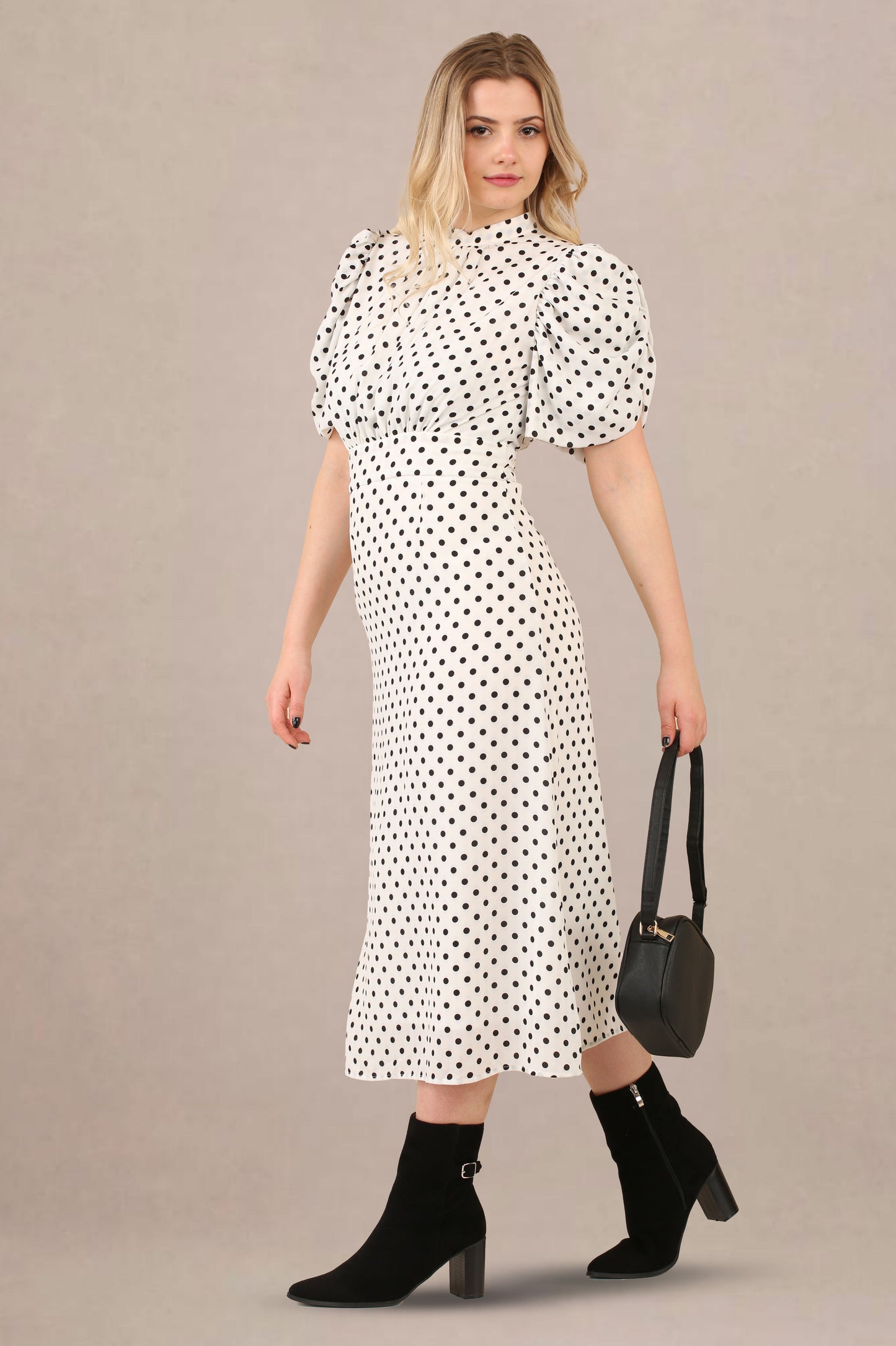 Side look of vintage-inspired puff sleeves polka dot midi dress