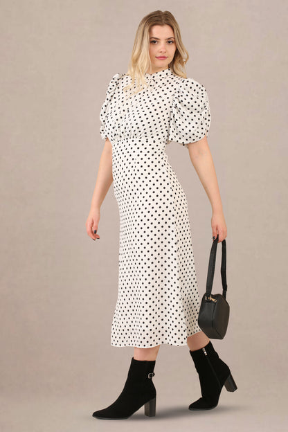 Side look of vintage-inspired puff sleeves polka dot midi dress