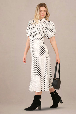 Side look of vintage-inspired puff sleeves polka dot midi dress