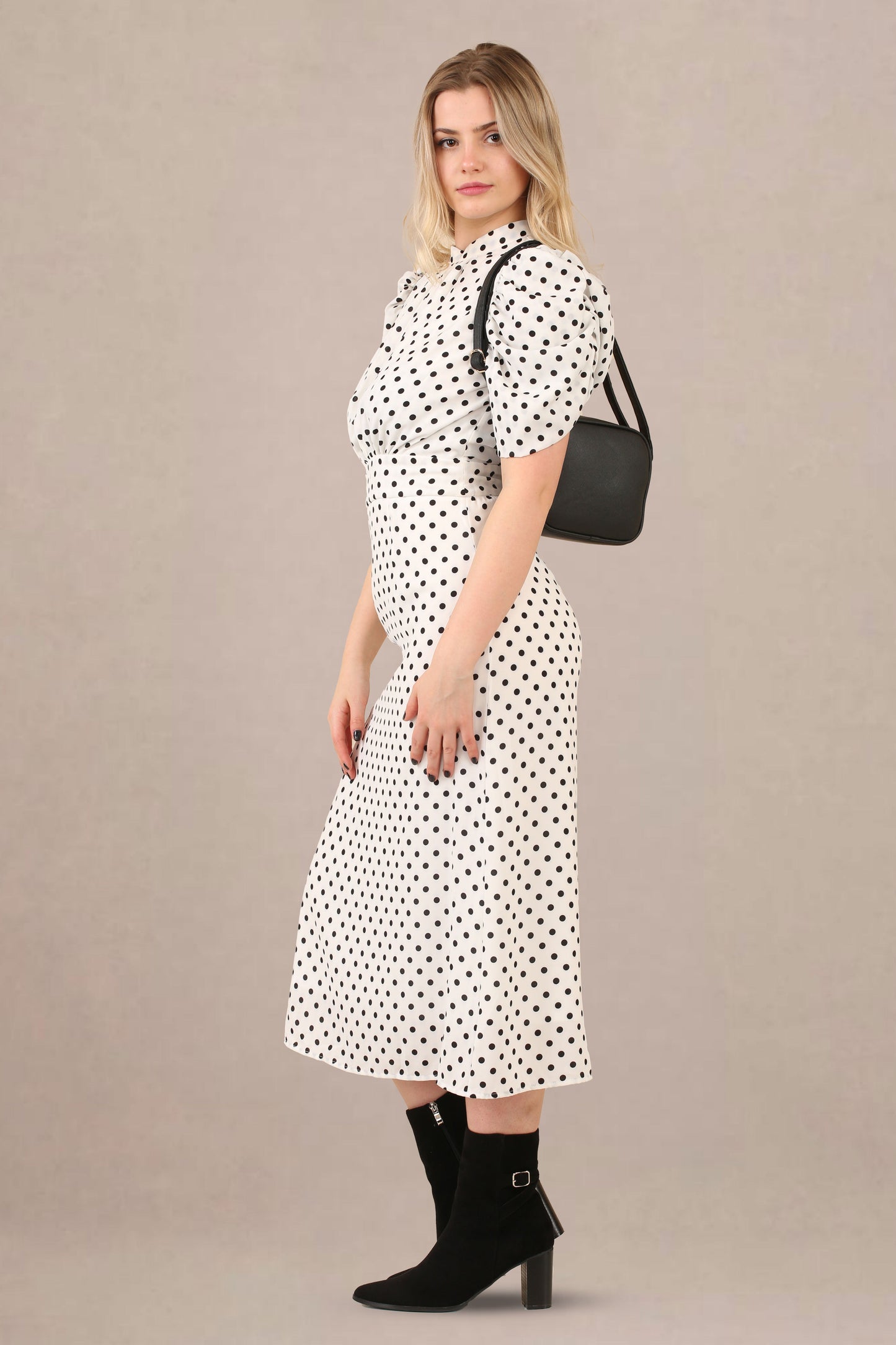 Side view of vintage-inspired puff sleeves polka dot midi dress