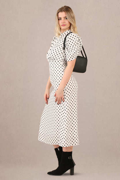 Side view of vintage-inspired puff sleeves polka dot midi dress