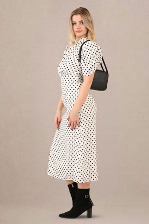 Side view of vintage-inspired puff sleeves polka dot midi dress
