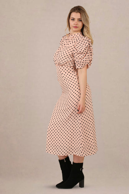 Side view of vintage-inspired puff sleeves polka dot midi dress