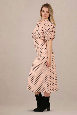 Side view of vintage-inspired puff sleeves polka dot midi dress