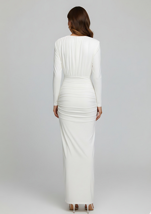 Woman wearing a white long-sleeve dress on a gray background