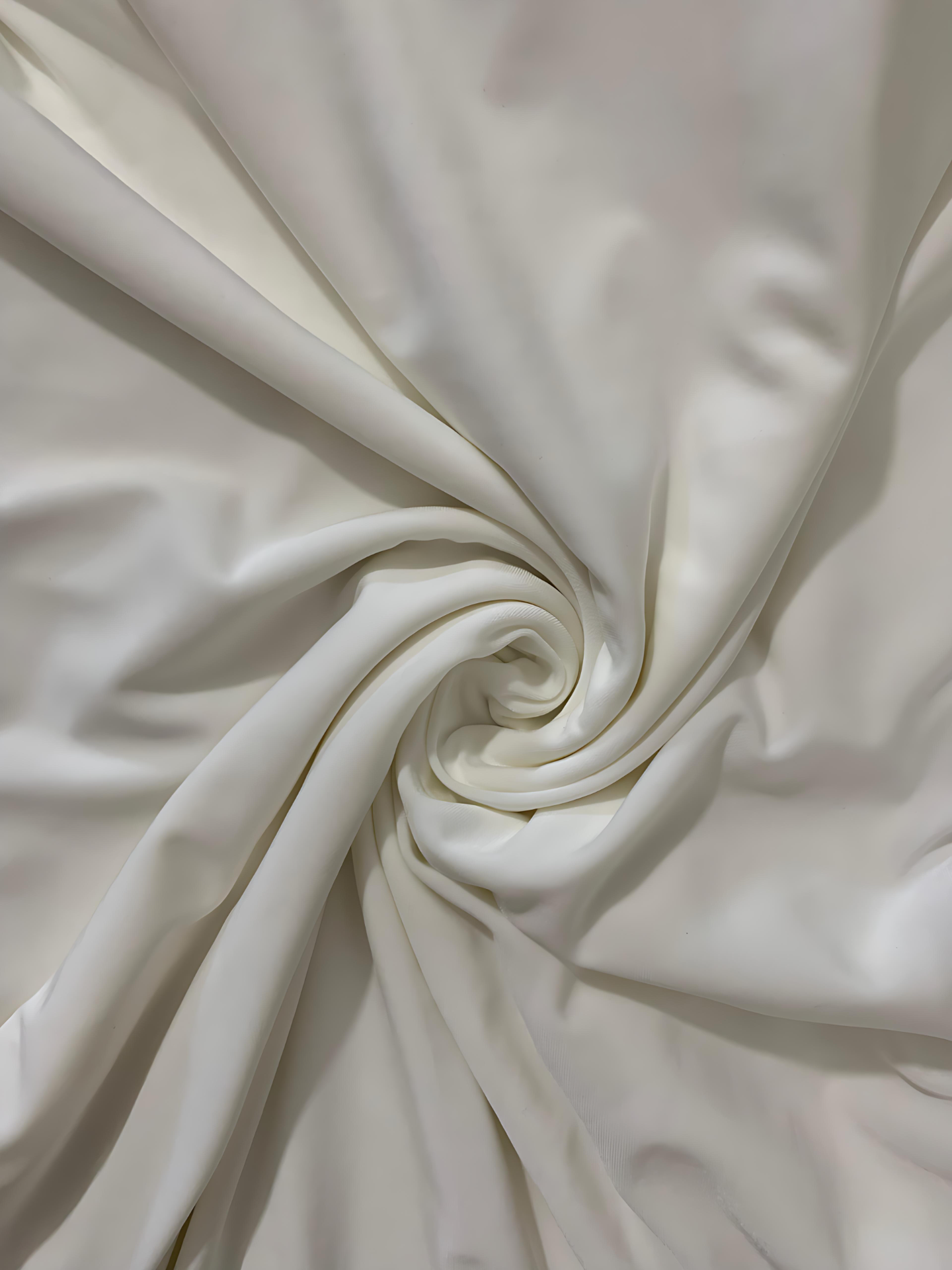 Close-up of white fabric with a swirl pattern